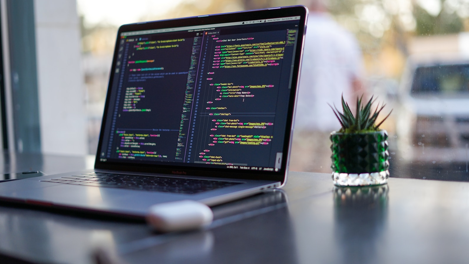 A QA engineer reviewing application code on a laptop